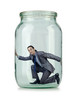 Young businessman in glass jar