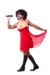 Man in female clothing singing with mic