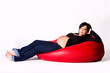 Pregnant woman on a red sako pillow