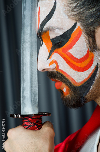 Photo: Man with sword and face mask Man with sword and face mask