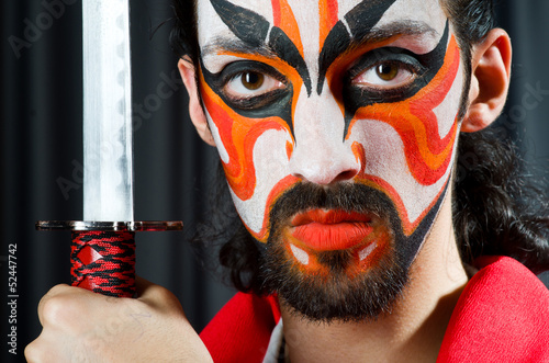 Photo: Man with sword and face mask Man with sword and face mask