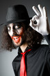 Joker personification with man in dark room