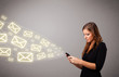 attractive young lady holding a phone with message icons