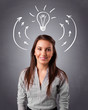 Photo: Pretty lady thinking with arrows and light bulb overhead Pretty lady thinking with arrows and light bulb overhead