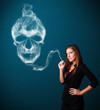 Young woman smoking dangerous cigarette with toxic skull smoke