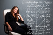Beautiful school girl thinking about complex mathematical signs