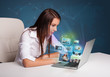 Foto: Beautiful girl sitting at desk and watching her photo gallery on Beautiful girl sitting at desk and watching her photo gallery on