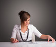 Businesswoman sitting at desk and doing paperwork