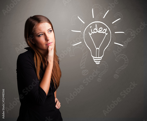 Photo: Young girl comming up with a light bubl idea sign Young girl comming up with a light bubl idea sign
