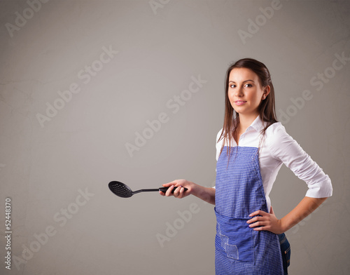 Photo: Pretty woman holding a spoon Pretty woman holding a spoon