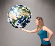 사진:Pretty girl holding 3d planet earth Pretty girl holding 3d planet earth