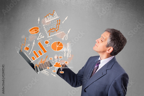 Photo: Businessman holding notebook with graphs and statistics Businessman holding notebook with graphs and statistics