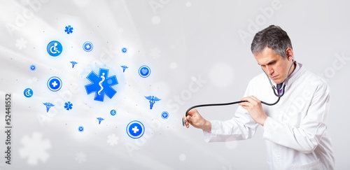 Photo: Doctor with blue medical icons Doctor with blue medical icons