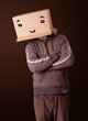Young man gesturing with a cardboard box on his head with smiley