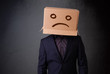 Young man with a brown cardboard box on his head with sad face