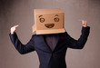 Young man gesturing with a cardboard box on his head with smiley