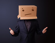 Young man gesturing with a cardboard box on his head with straig
