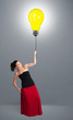 Pretty lady holding a light bulb balloon