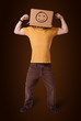 Young man gesturing with a cardboard box on his head with smiley