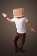 Young man gesturing with a cardboard box on his head