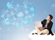 Happy businessman sitting on cloud with cloud computing