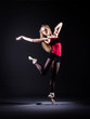Ballerina dancing in the dark studio