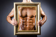 Muscular man with picture frame
