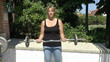 Footage of a young female weight training