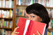 Photo: Asian girl in library reading a book Asian girl in library reading a book