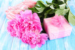 Photo: Beautiful peonies on table close-up Beautiful peonies on table close-up