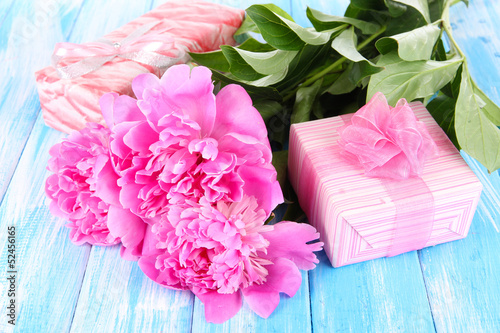 Photo: Beautiful peonies on table close-up Beautiful peonies on table close-up