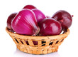 Purple onion in wicker basket isolated on white