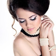 Closeup portrait of Beautiful woman with pearls and evening make
