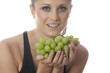 Foto: Model Released. Young Woman Holding a Bunch of Grapes Model Released. Young Woman Holding a Bunch of Grapes