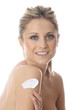 Model Released. Young Woman Applying Cream