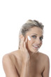 Model Released. Young Woman Applying Cream
