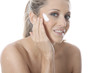 Model Released. Young Woman Applying Cream
