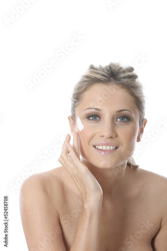 Photo: Model Released. Young Woman Applying Cream Model Released. Young Woman Applying Cream