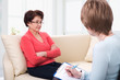 An elderly woman talking to psychologist