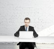 Photo: man sitting at a table man sitting at a table