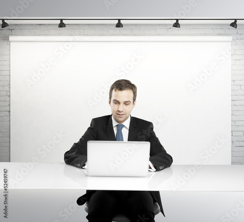 Photo: man with laptop in studio man with laptop in studio