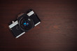 Old film camera on a wooden table