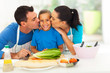 Photo: loving parents kissing little daughter loving parents kissing little daughter