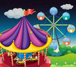 A carrousel with ferris wheel at the back