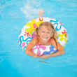little girl in the swimming pool  with rubber ring