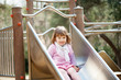 baby girl on slide at playground