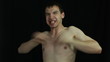 Funny mad naked man over dark background