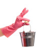 Hand in a pink glove holding silver pail