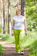  woman walking in pine forest
