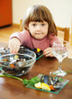   child eats mussels in home